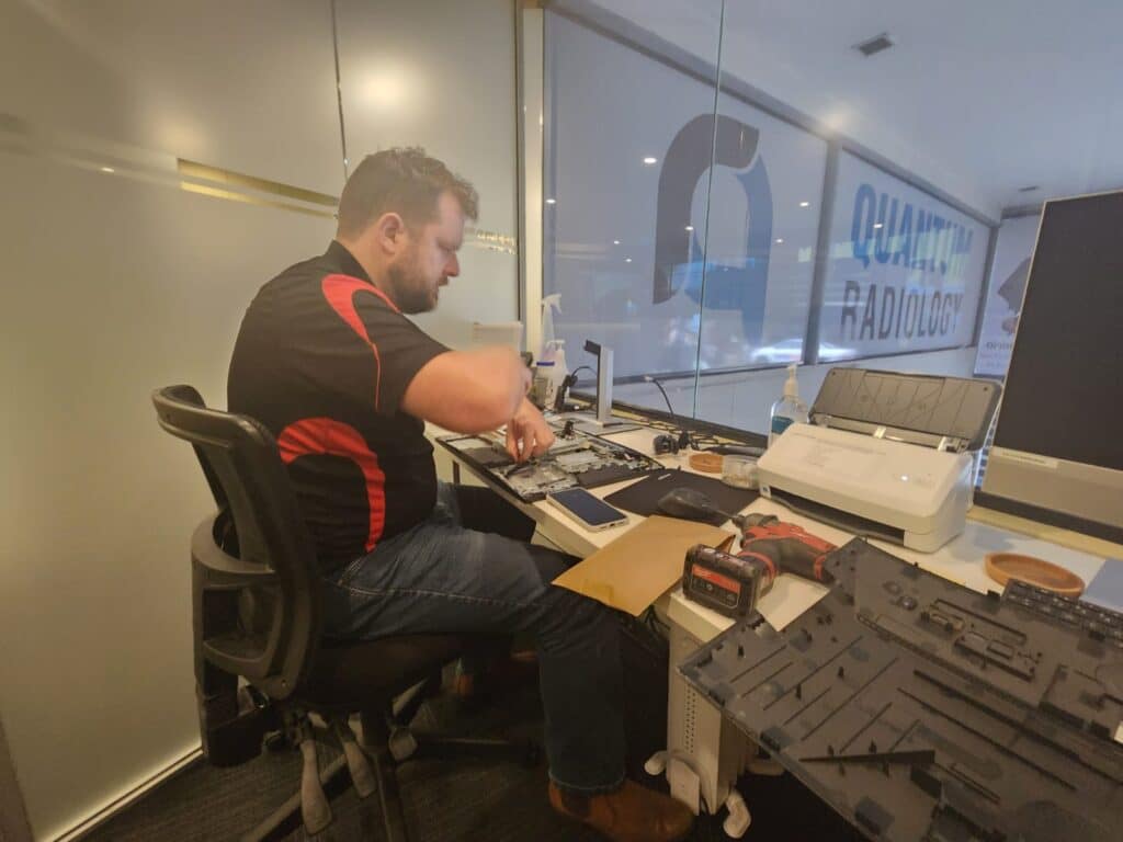 Technician working on HP All-in-One during memory upgrade