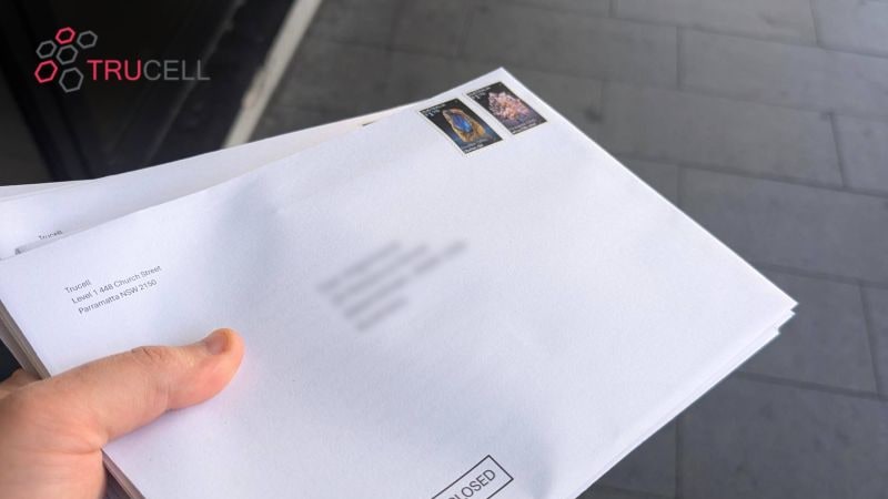 A bundle of Trucell DICOM test kit envelopes in hand, ready to ship to radiologists across Australia, addressed from Level 1, 448 Church Street, Parramatta